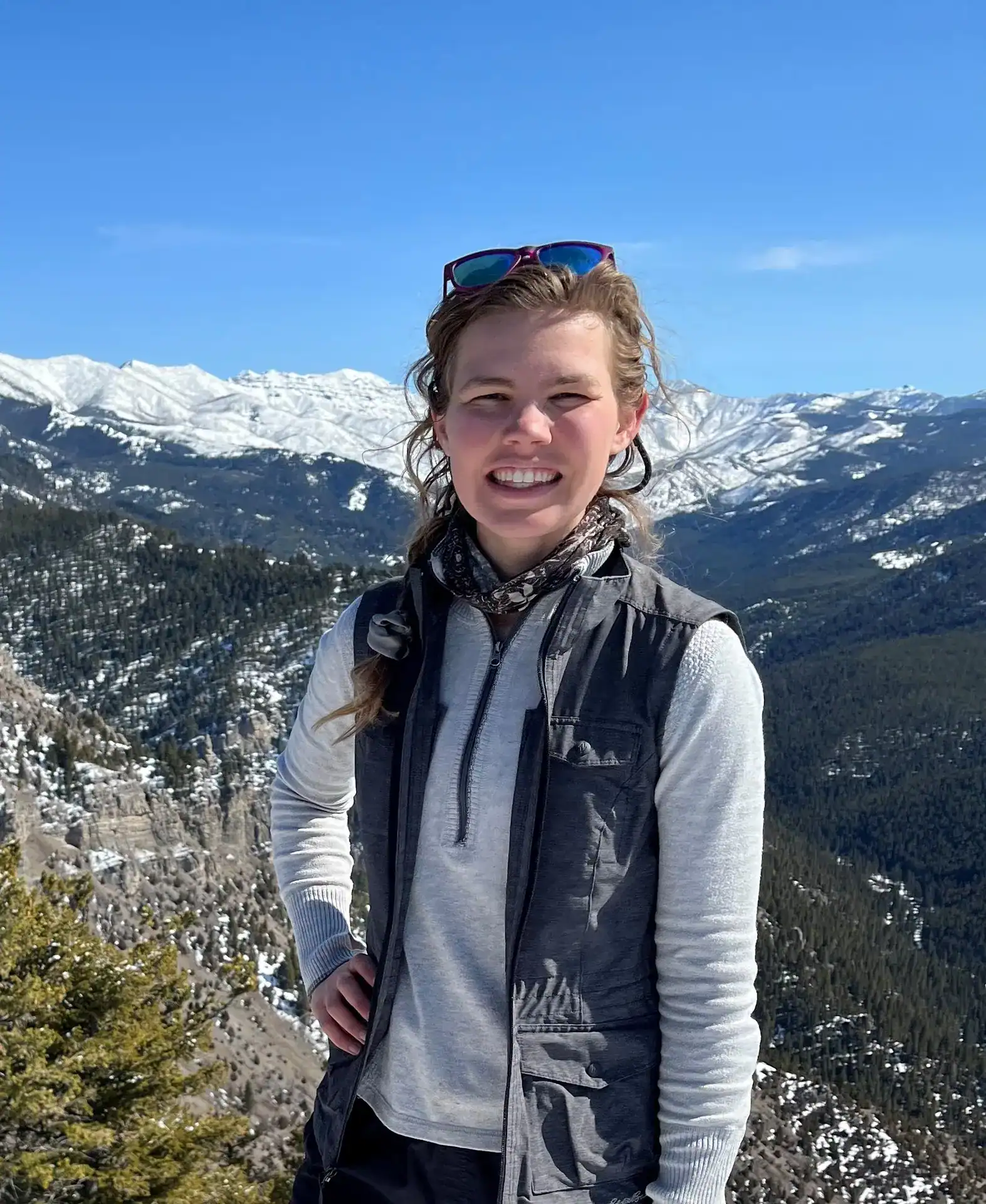 Youth hiking in snowy mountains, promoting outdoor adventure and environmental conservation.