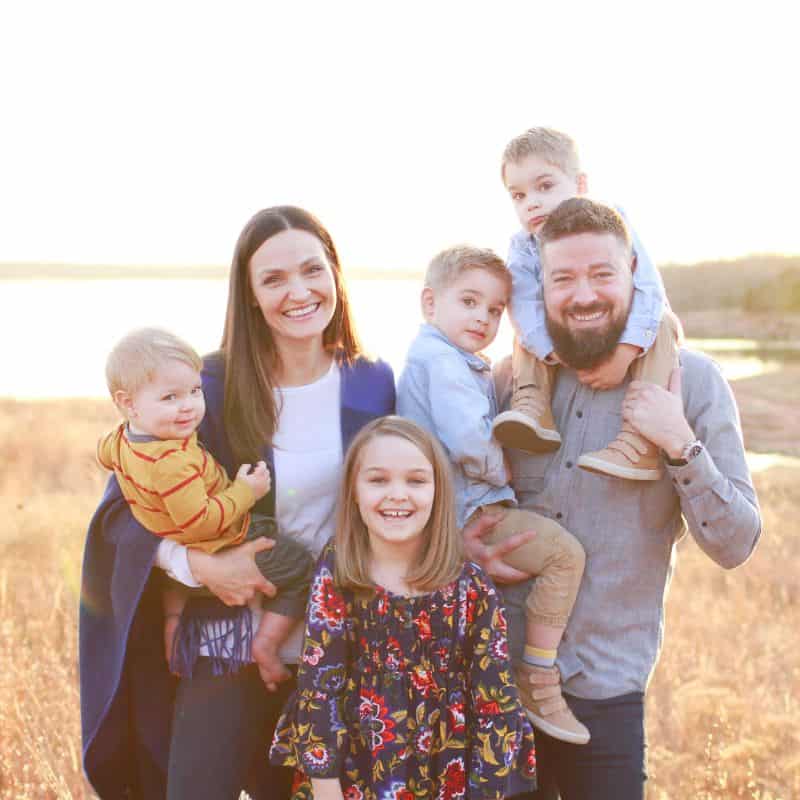 Smiling family outdoors promoting community and well-being with Coldwater Foundation.