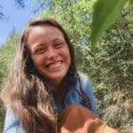 Bright smiling woman outdoors in nature, promoting Coldwater Foundation's 2025 initiatives and environmental impact.